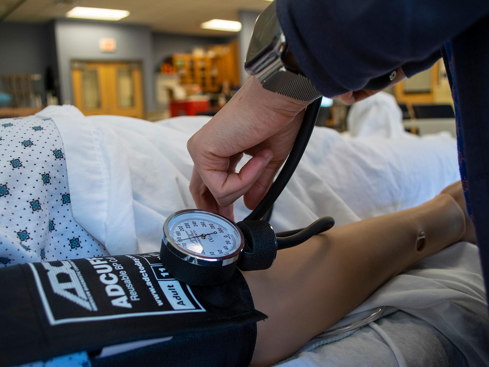 hands demonstrating use of blood pressure cuff