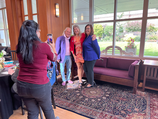woman taking a photo of a a group of people on her phone 