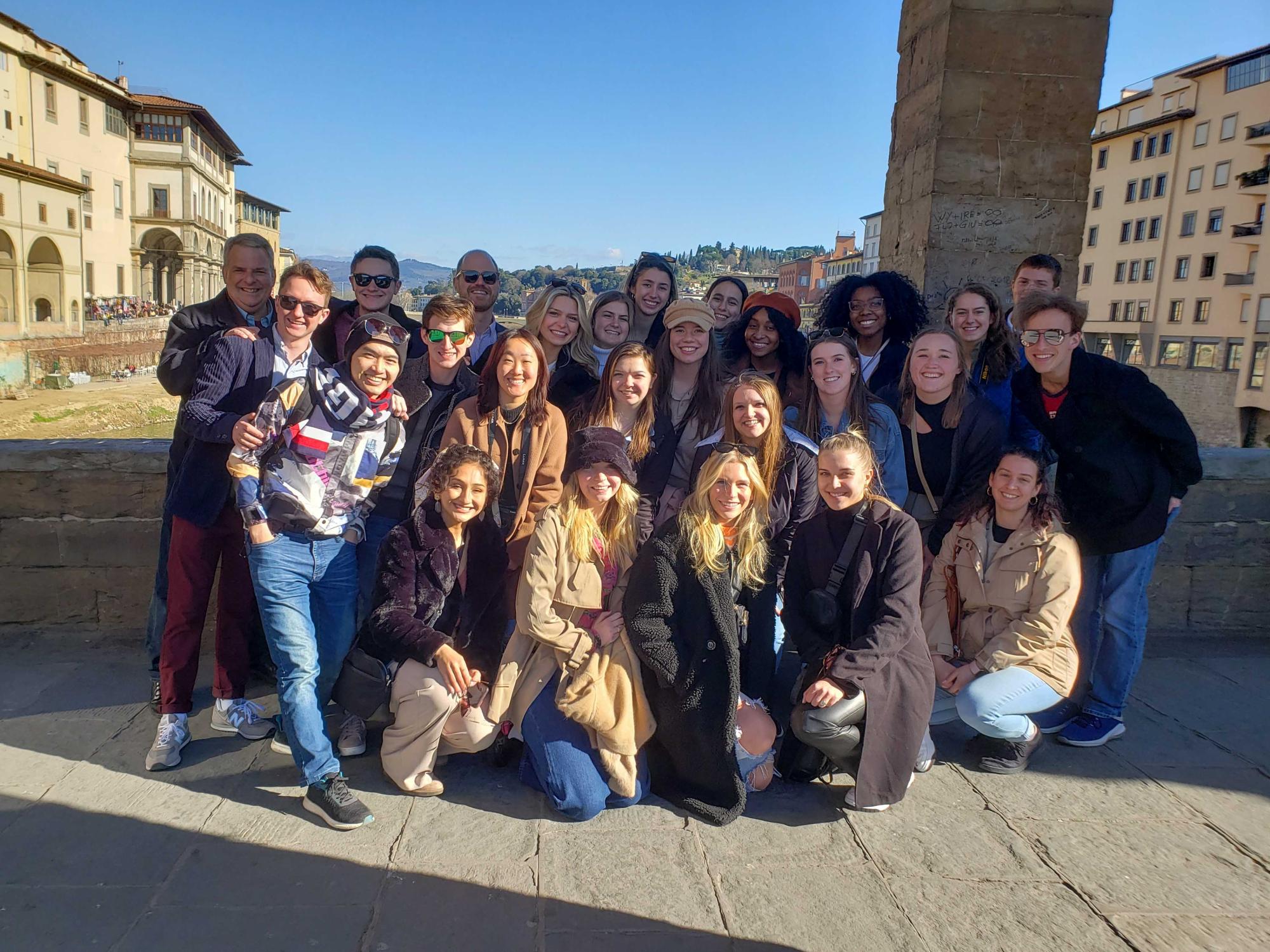 students pose on a bridge in Italy