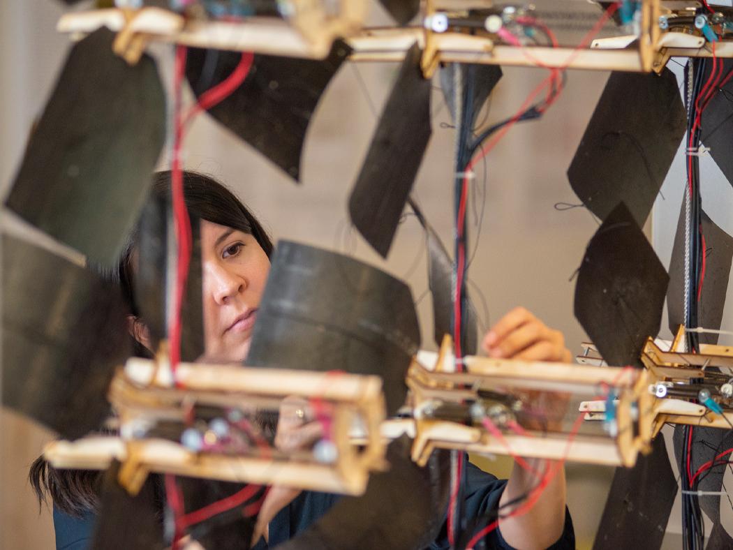 Elena Vazquez works on adjusting the kinetic shading device. 