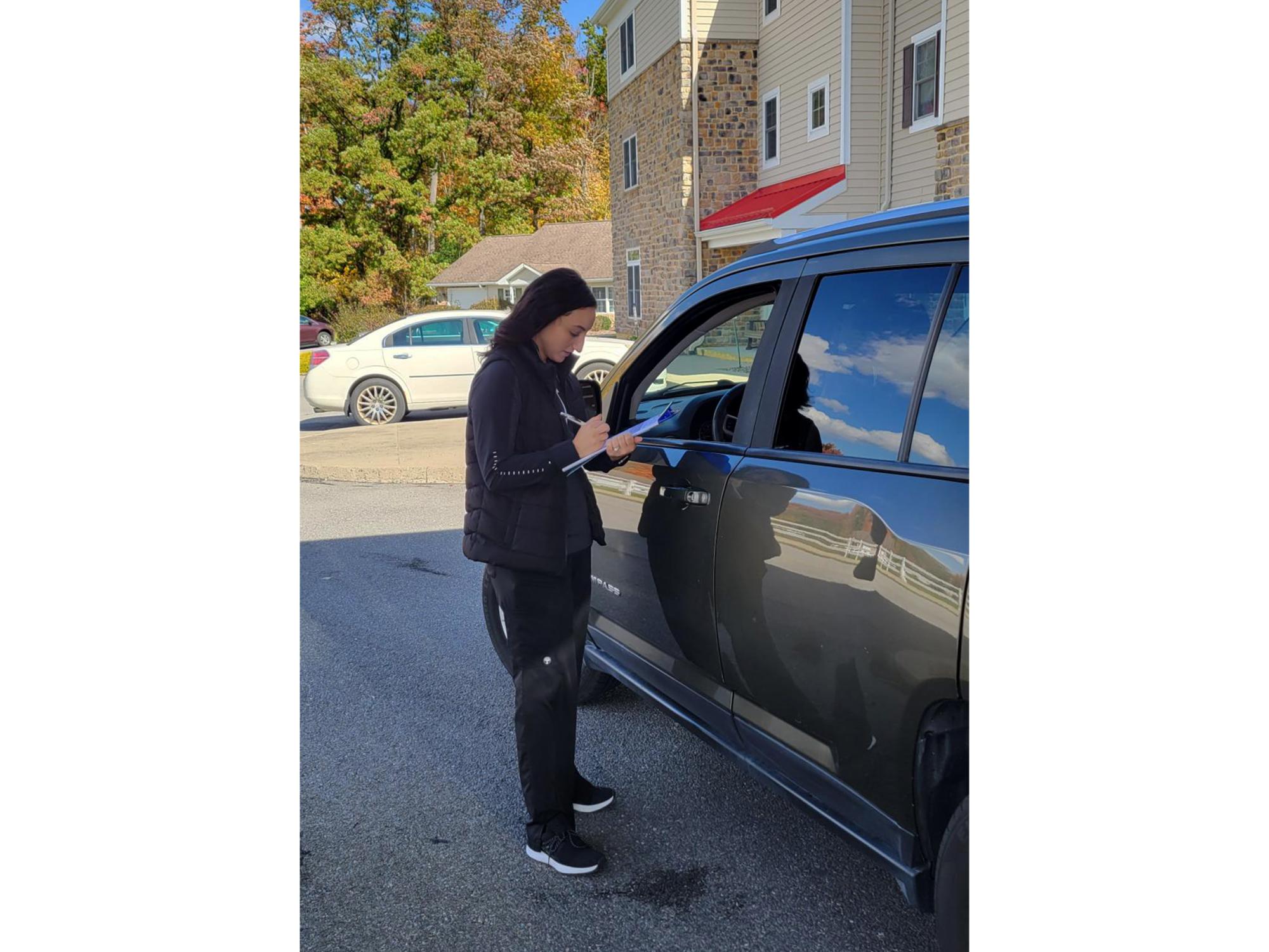 Penn State DuBois alumnus Haley Gray gathers information during an evaluation at the CarFit event at Windy Hill Village.