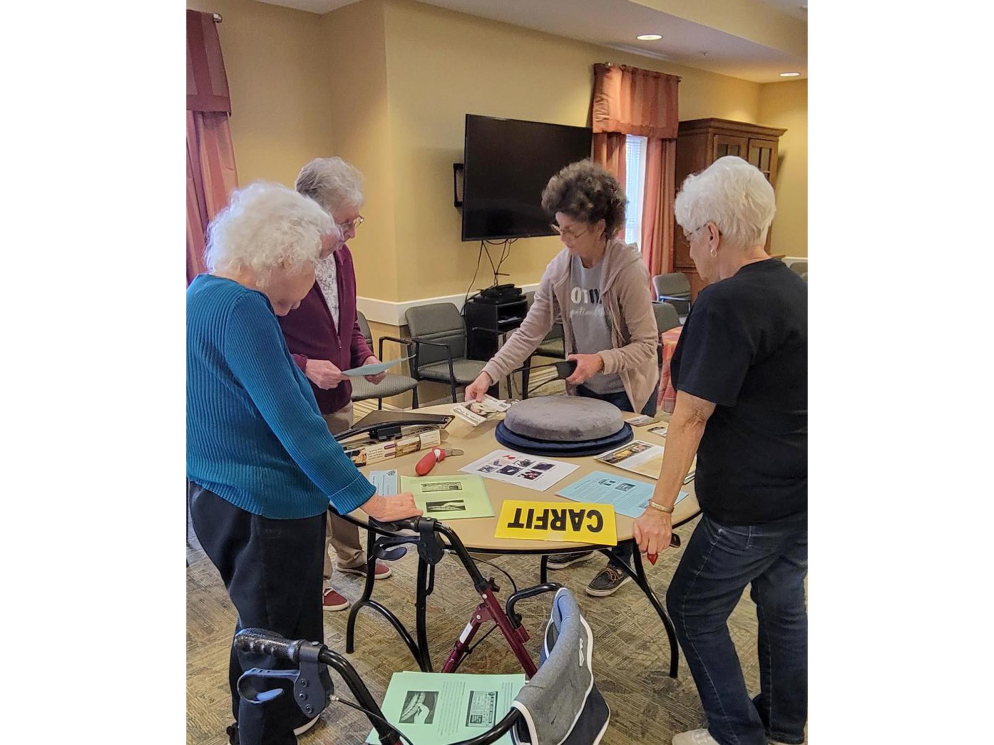LuAnn Delbrugge presents residents of Windy Hill Village with information at a CarFit event.