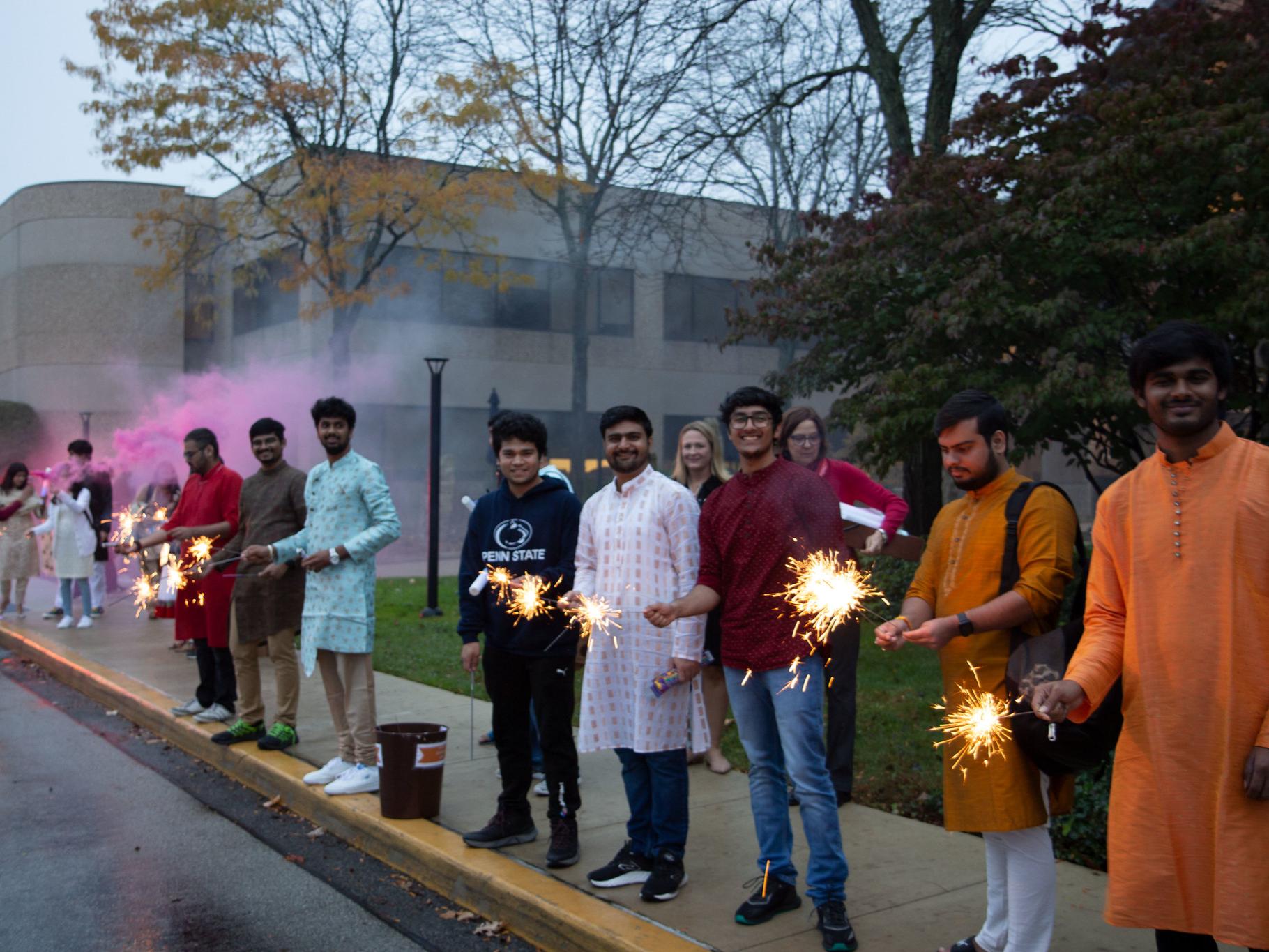 Students dressed up for Diwali lighting sparklers and firecrackers