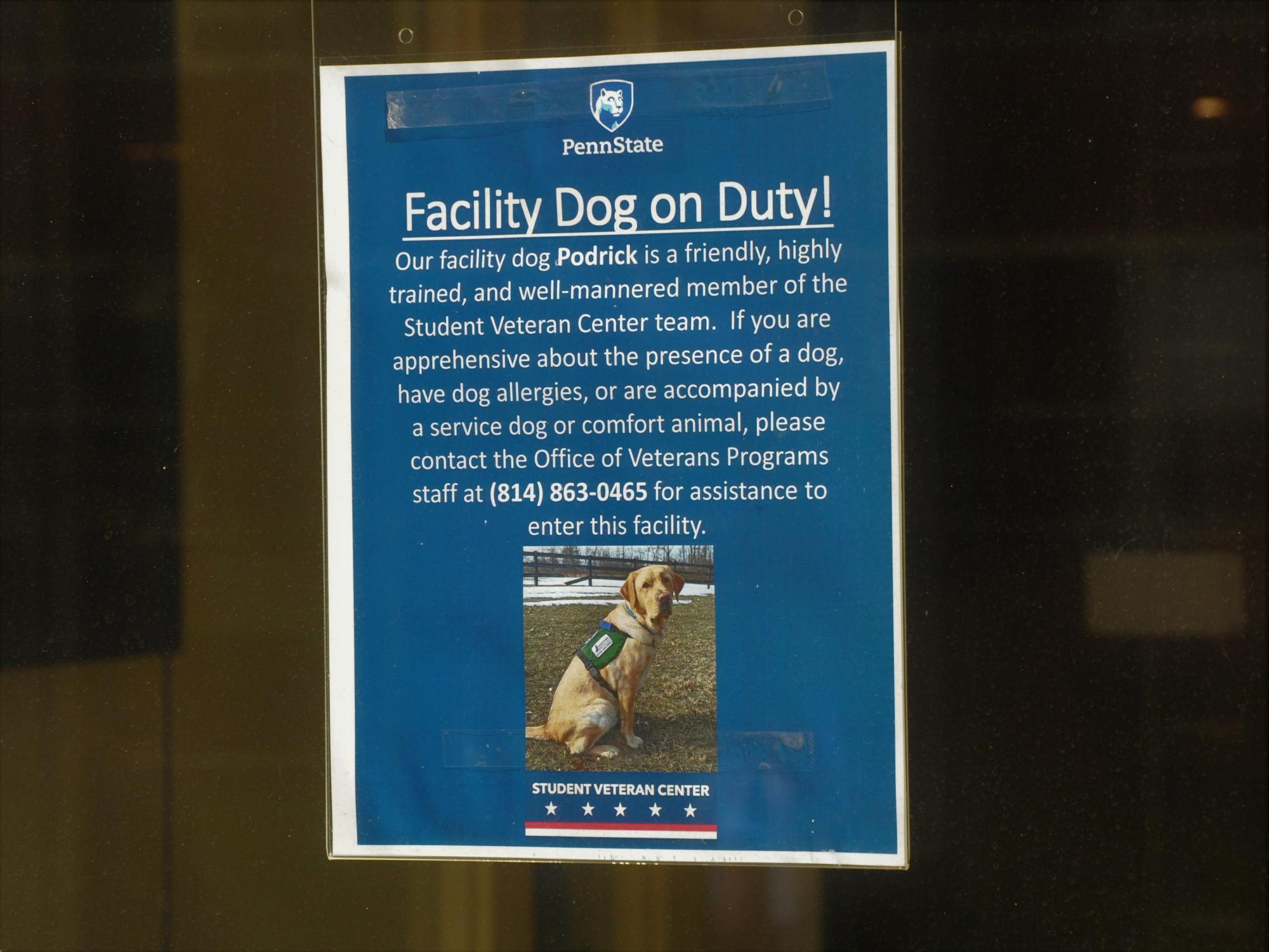 A sign taped to the door of the Student Veteran Center informing visitors about Podrick, the center's trained facility dog