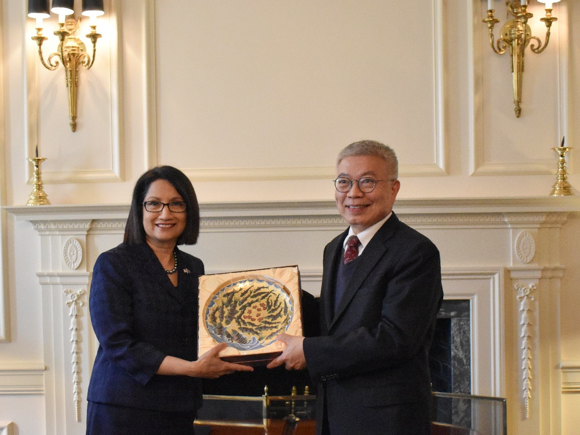 A man giving a woman a gift of an ornamental steel dish
