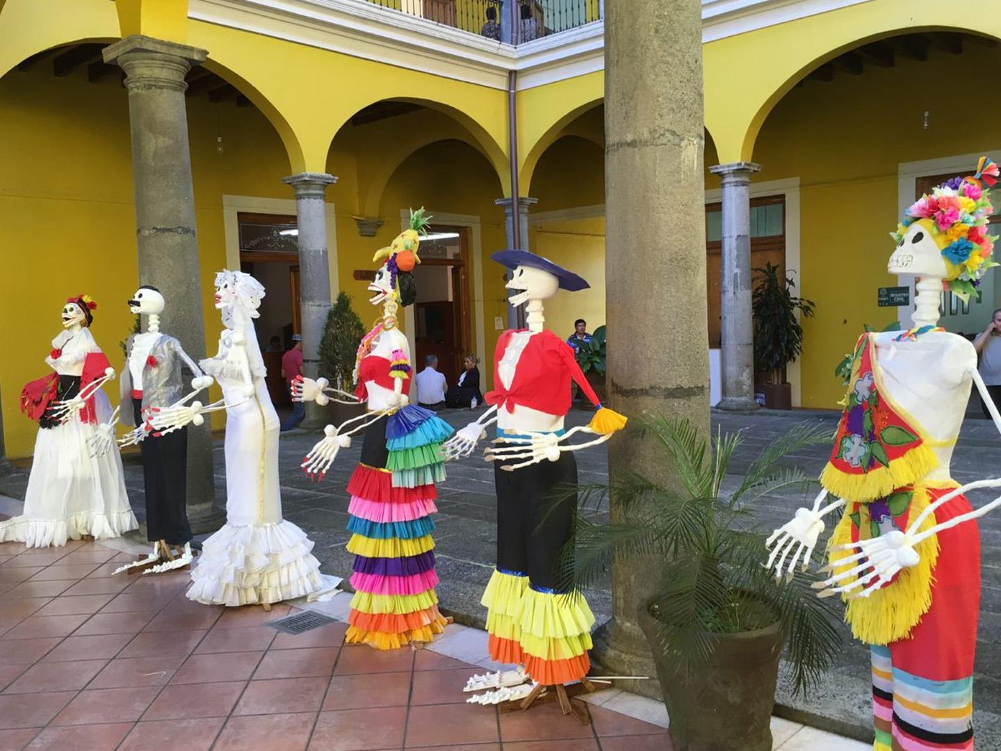Skeletons dressed in bright clothing