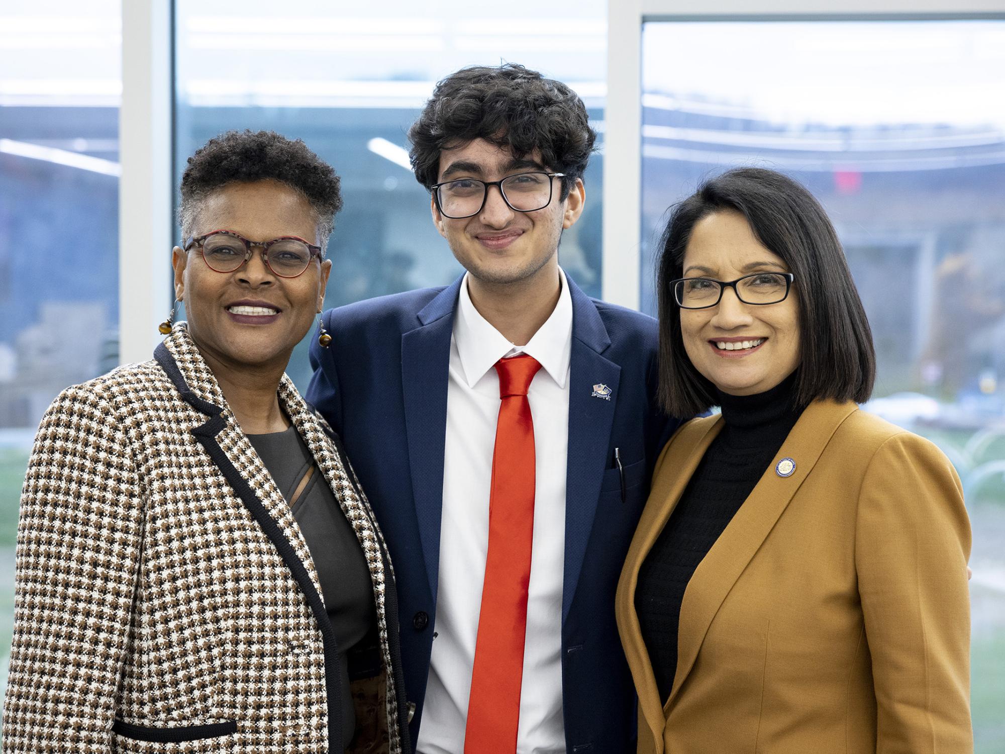Dr. Richardson, Kriday Sharoma, and President Bendapudi stand together and smile at the camera.