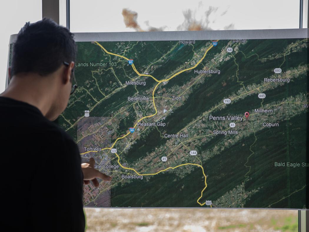 A student points at a map of the region where PennDOT is proposing a new highway.