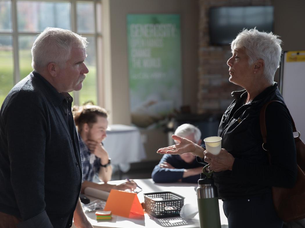 Paul Daniel Marriott, at left, speaks with a local resident during the community design charrette on Oct. 30.