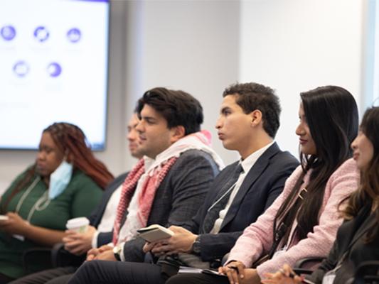 SIA students take notes during presentation. 