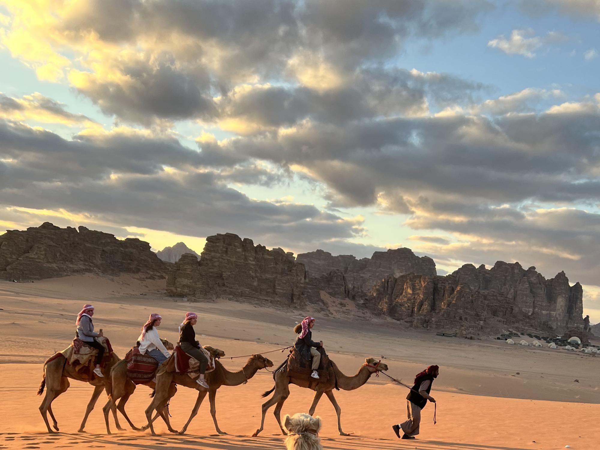 Luisina Kemanian-Leites (far left) rides a camel in Wadi Rum, Jordan.