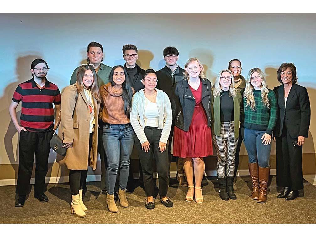 A large group of students and business officials standing together.