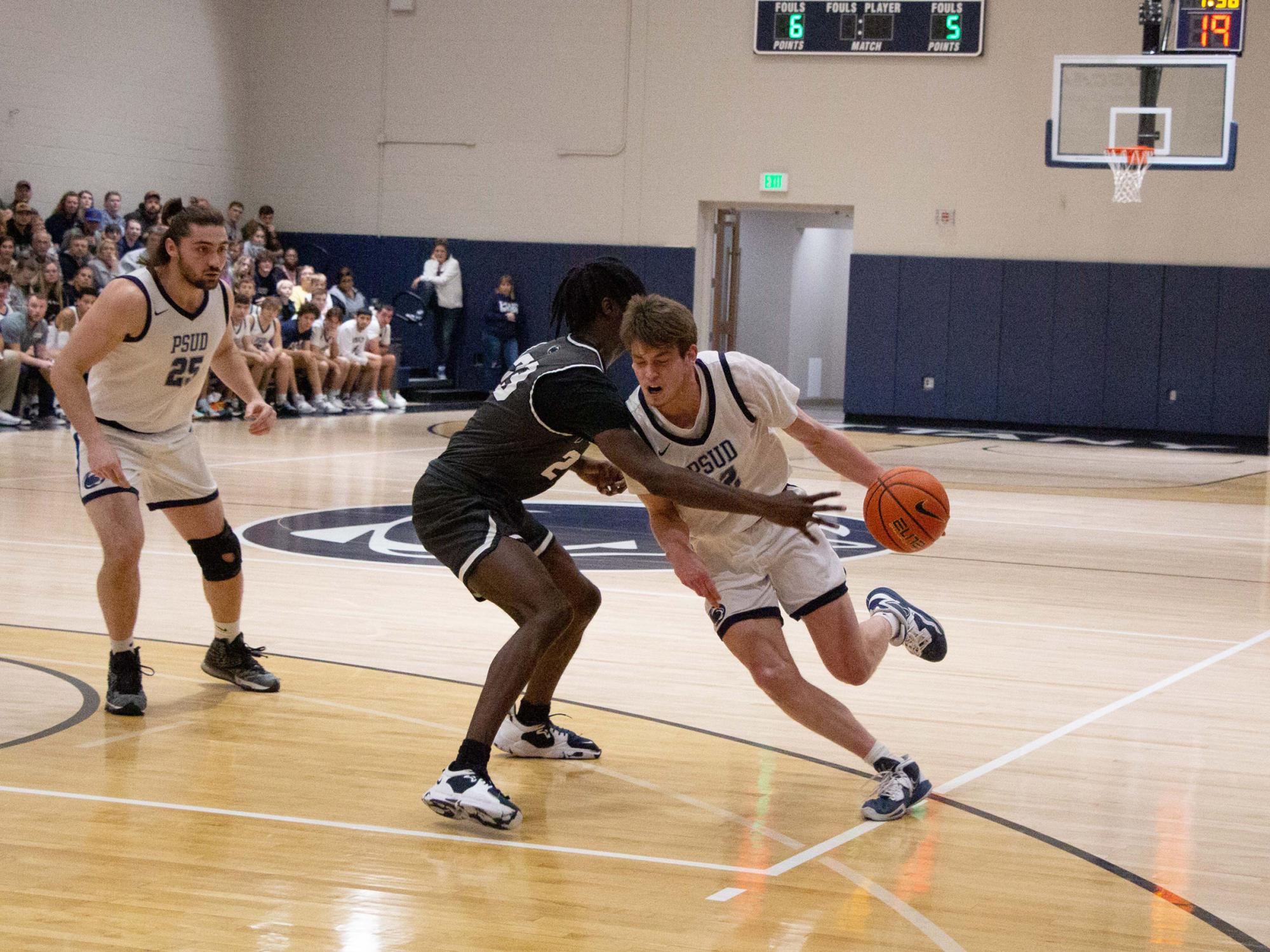 Penn State DuBois junior forward Will Helton drives past the reach of his defender during the contest with Penn State New Kensington at the PAW Center