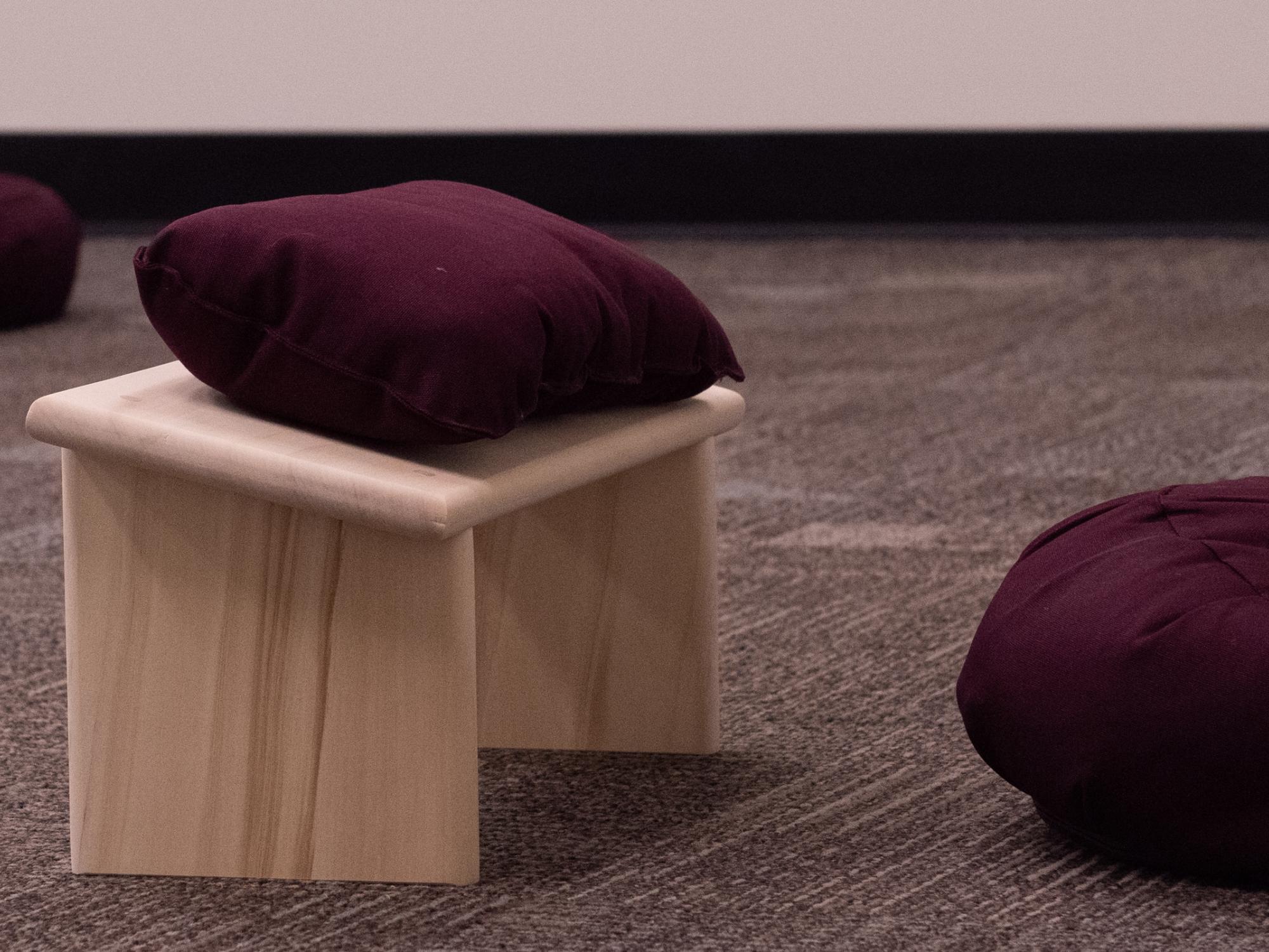 Praying cushions in the meditation space in Boucke Building line the floor