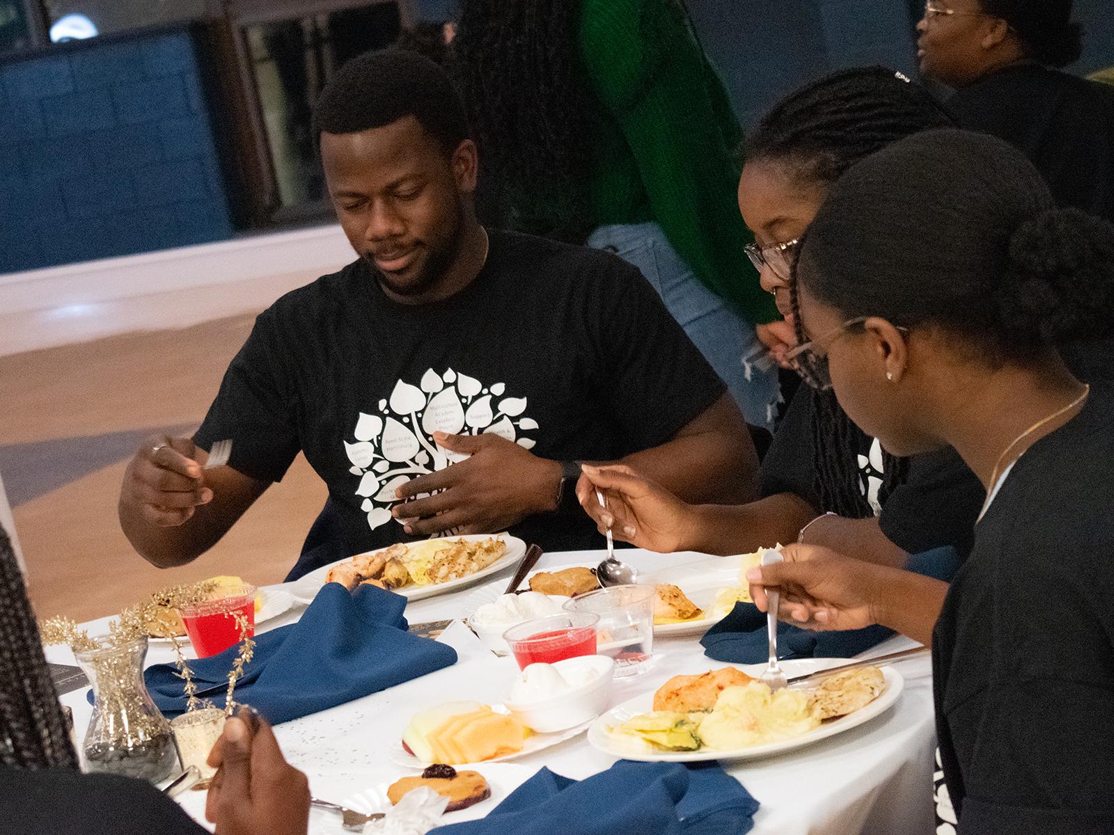 Students eat dinner during the anniversary celebration for the Multicultural Academic Excellence Program.