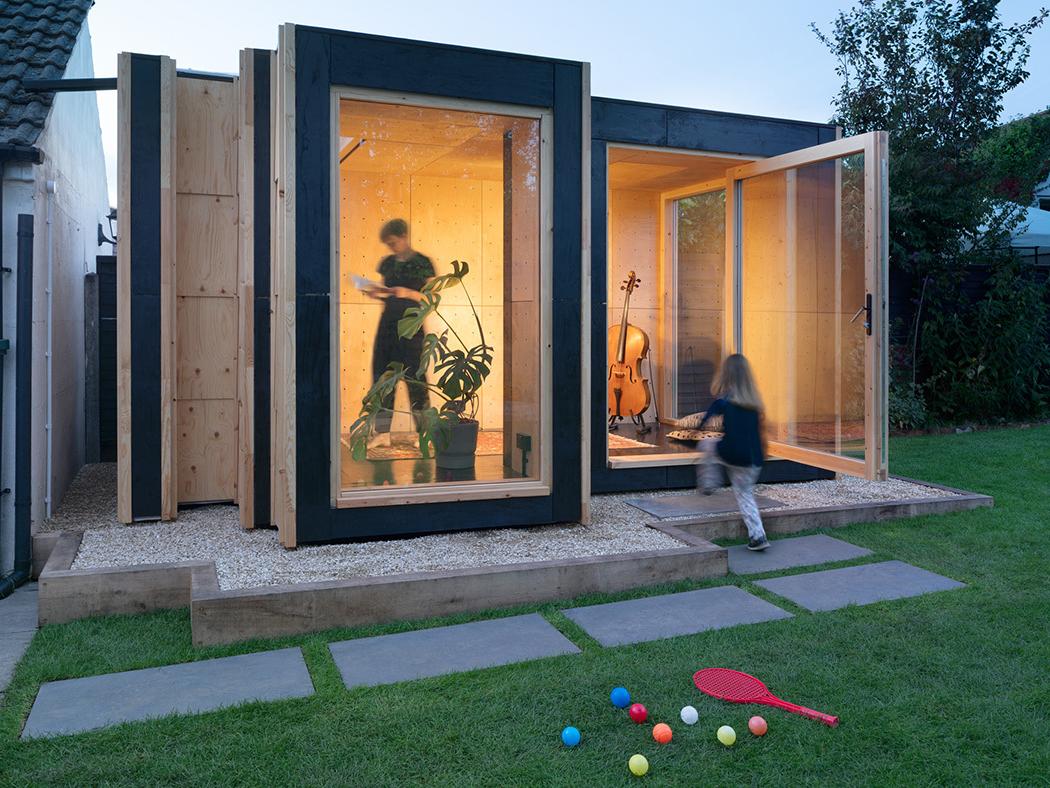 An architectural rendering of a house with large windows that looks out over a backyard.