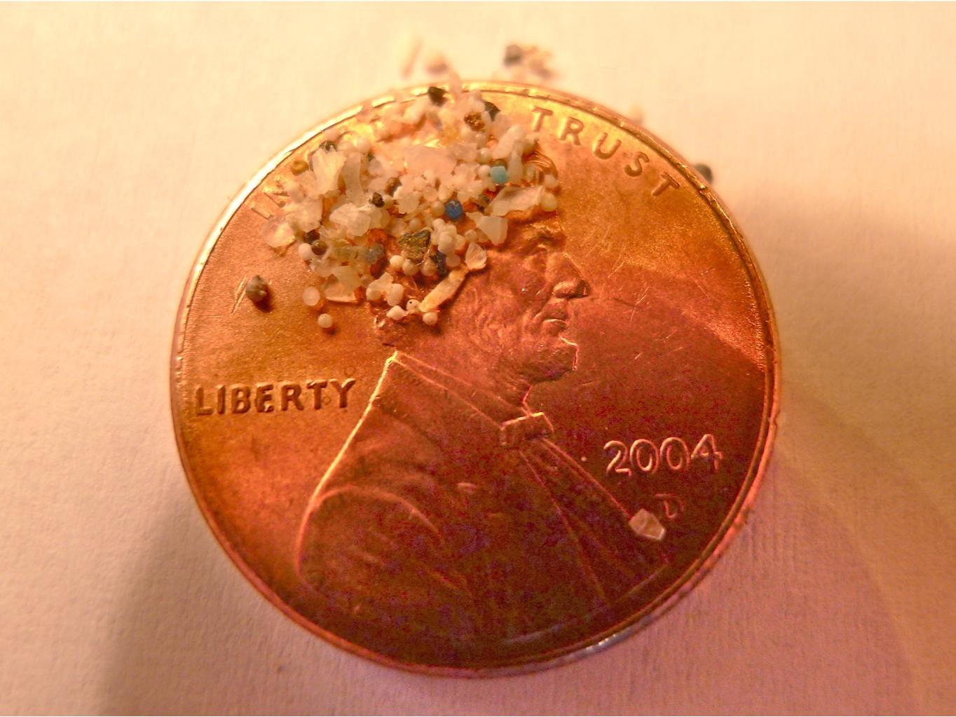 Microbeads of plastic sitting on a penny
