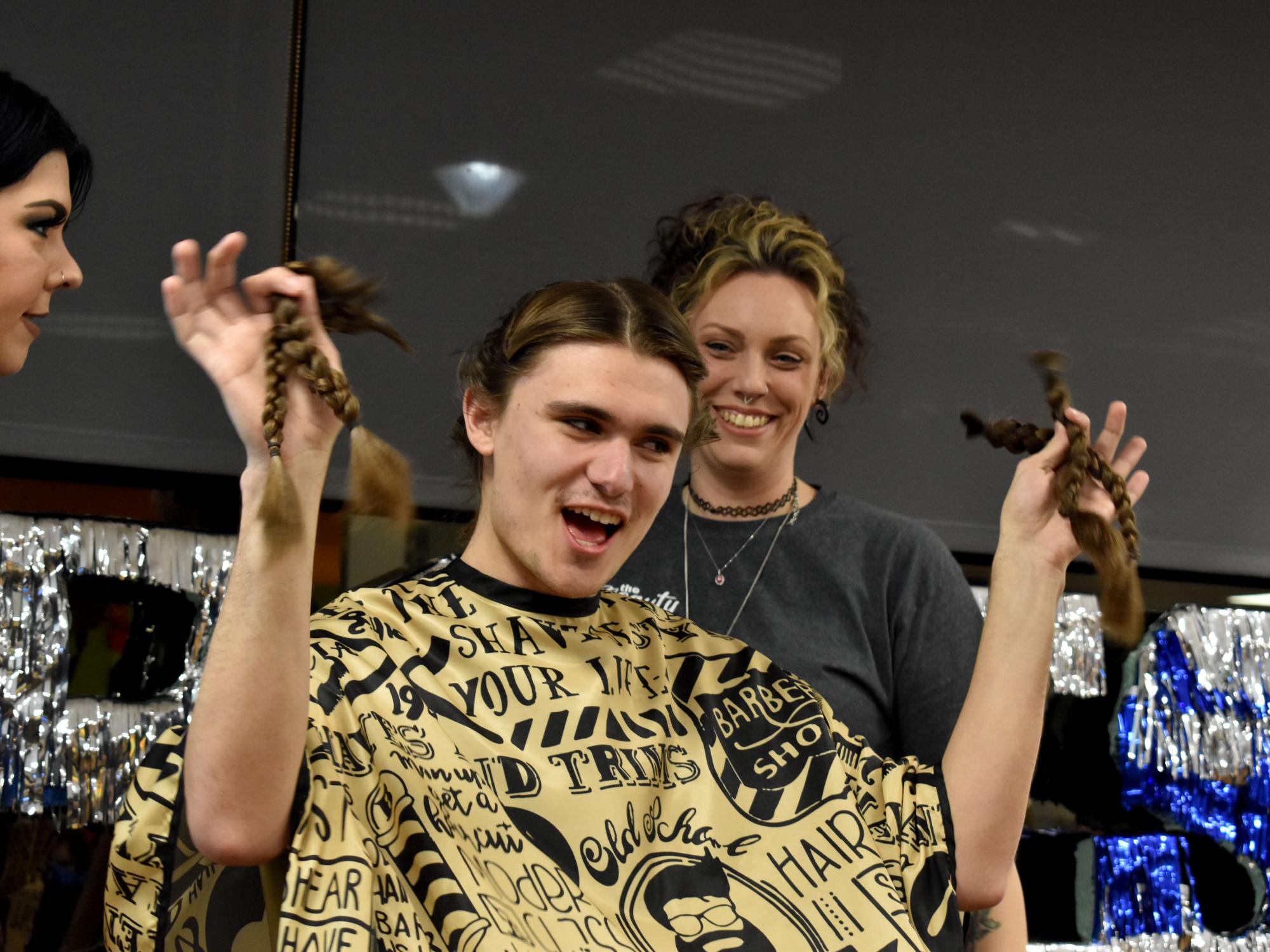 Penn State DuBois student and THON dancer Gaven Wolfgang proudly displays his freshly cut hair at the hair auction