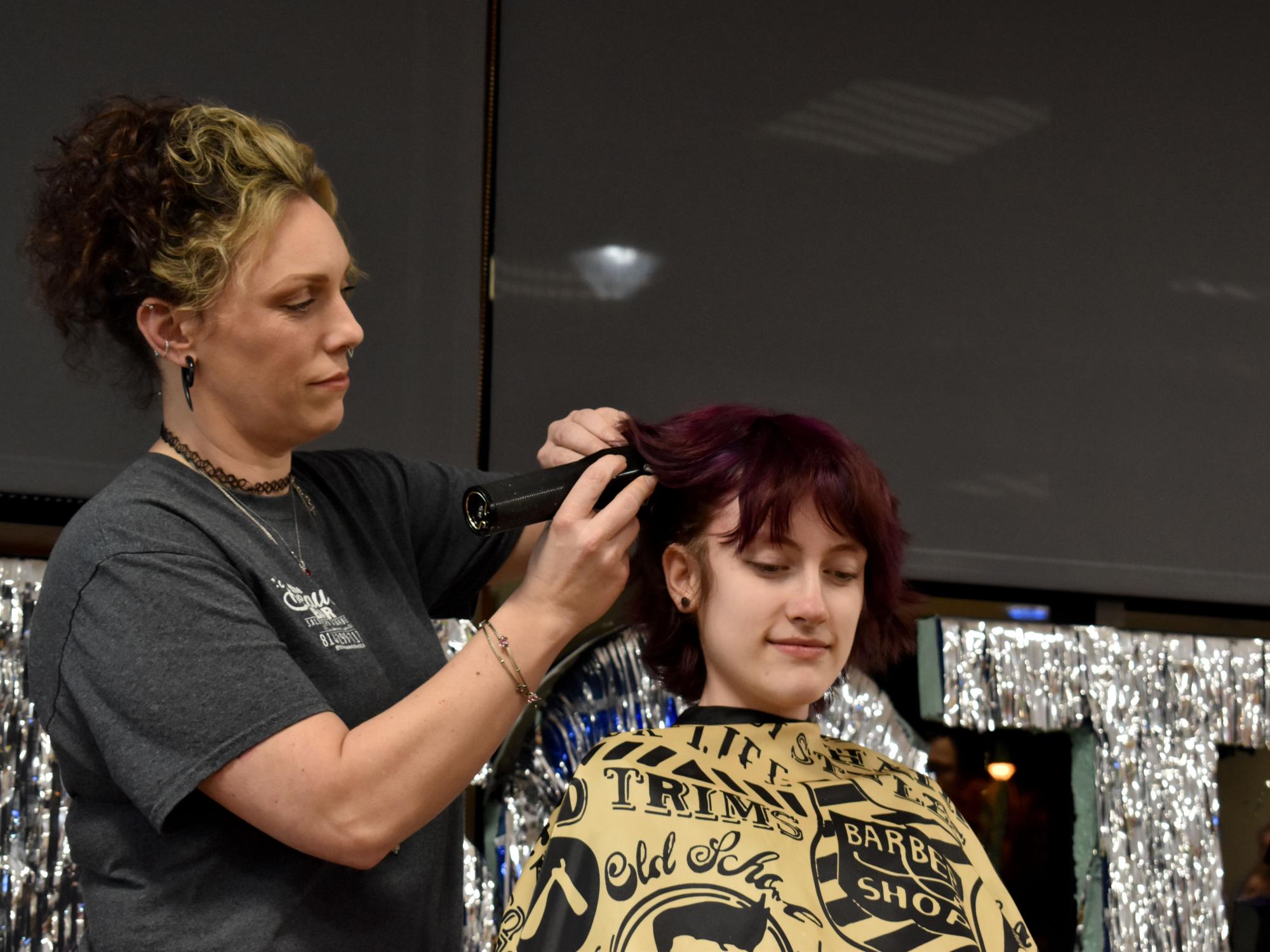 Marilla Mancuso has her hair buzzed during the THON hair auction at Penn State DuBois