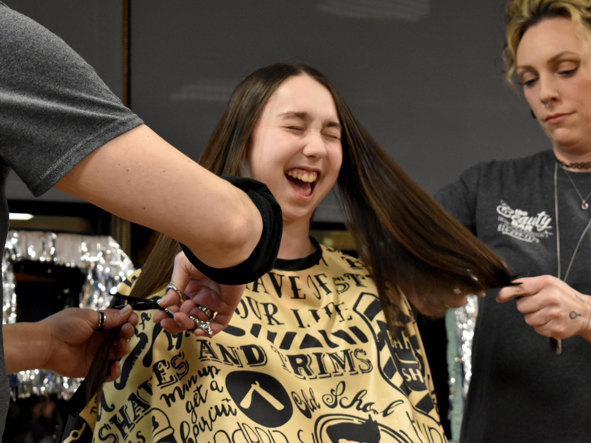 Elise Dufour shows her excitement as her hair is cut during the THON hair auction