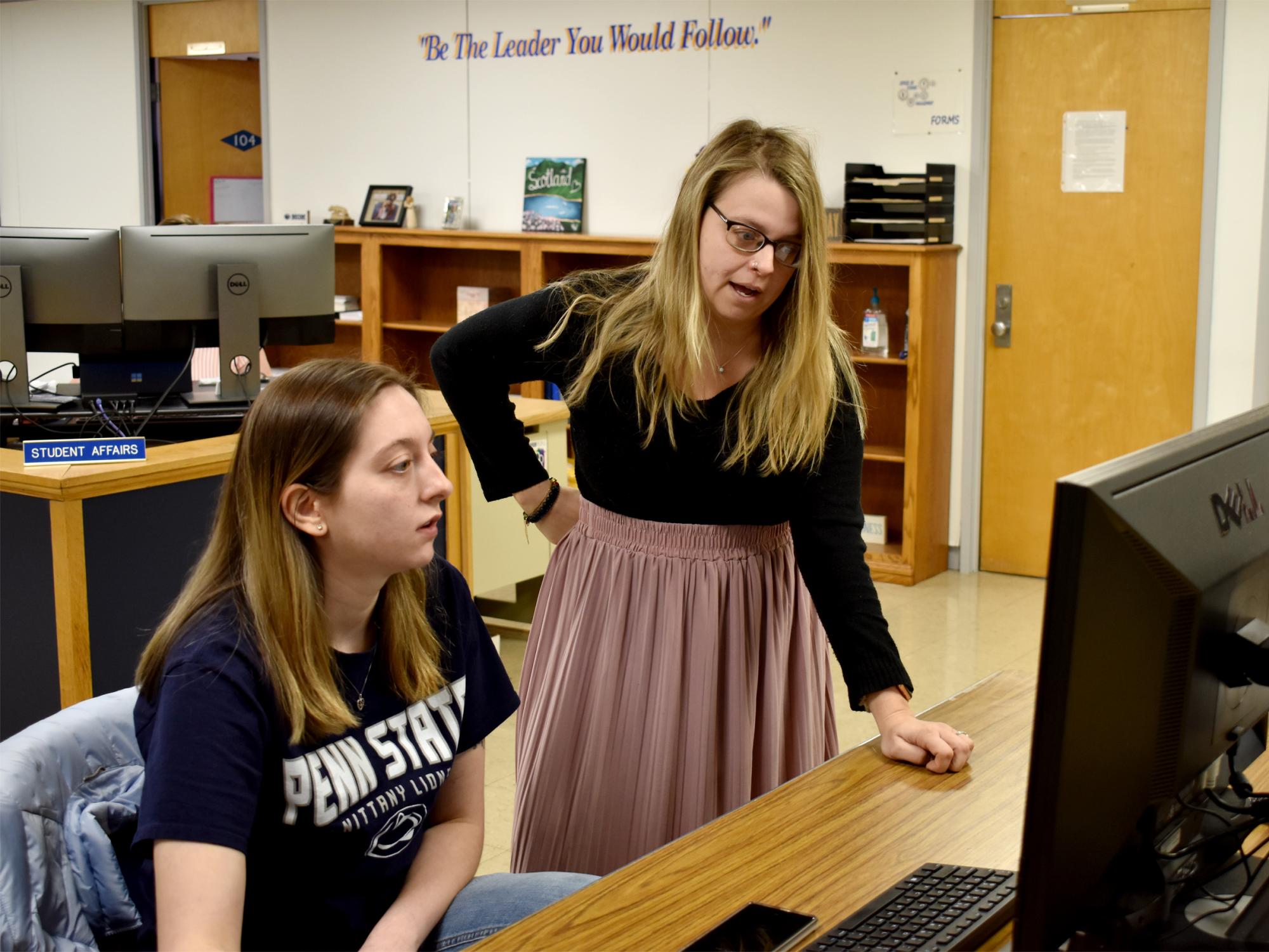 Taylor Charles reviewing information with Brittany Stanton, assistant director of student engagement, as part of her logistics internship at Penn State DuBois