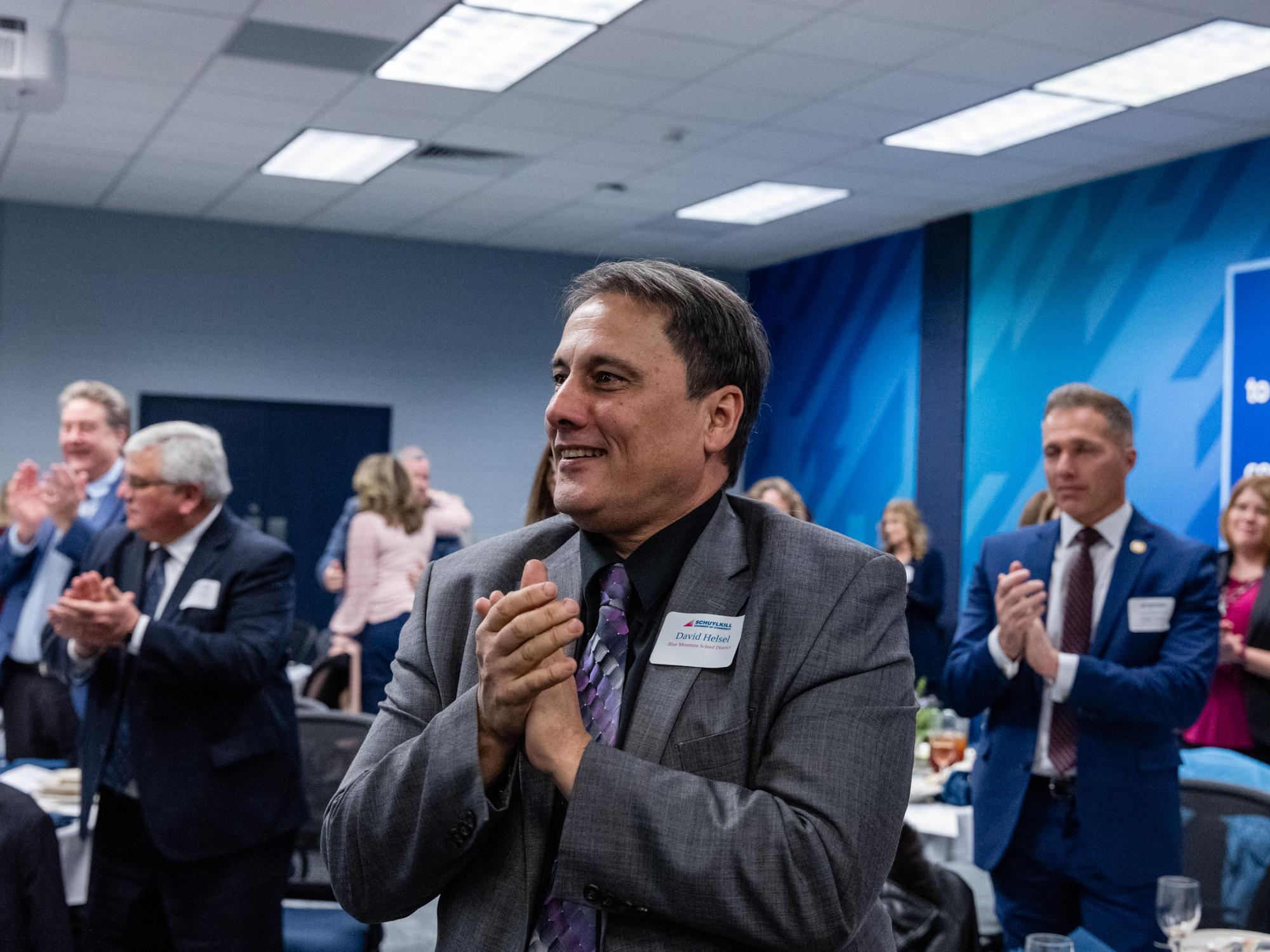 Attendees applaud at the Business Executive Forum