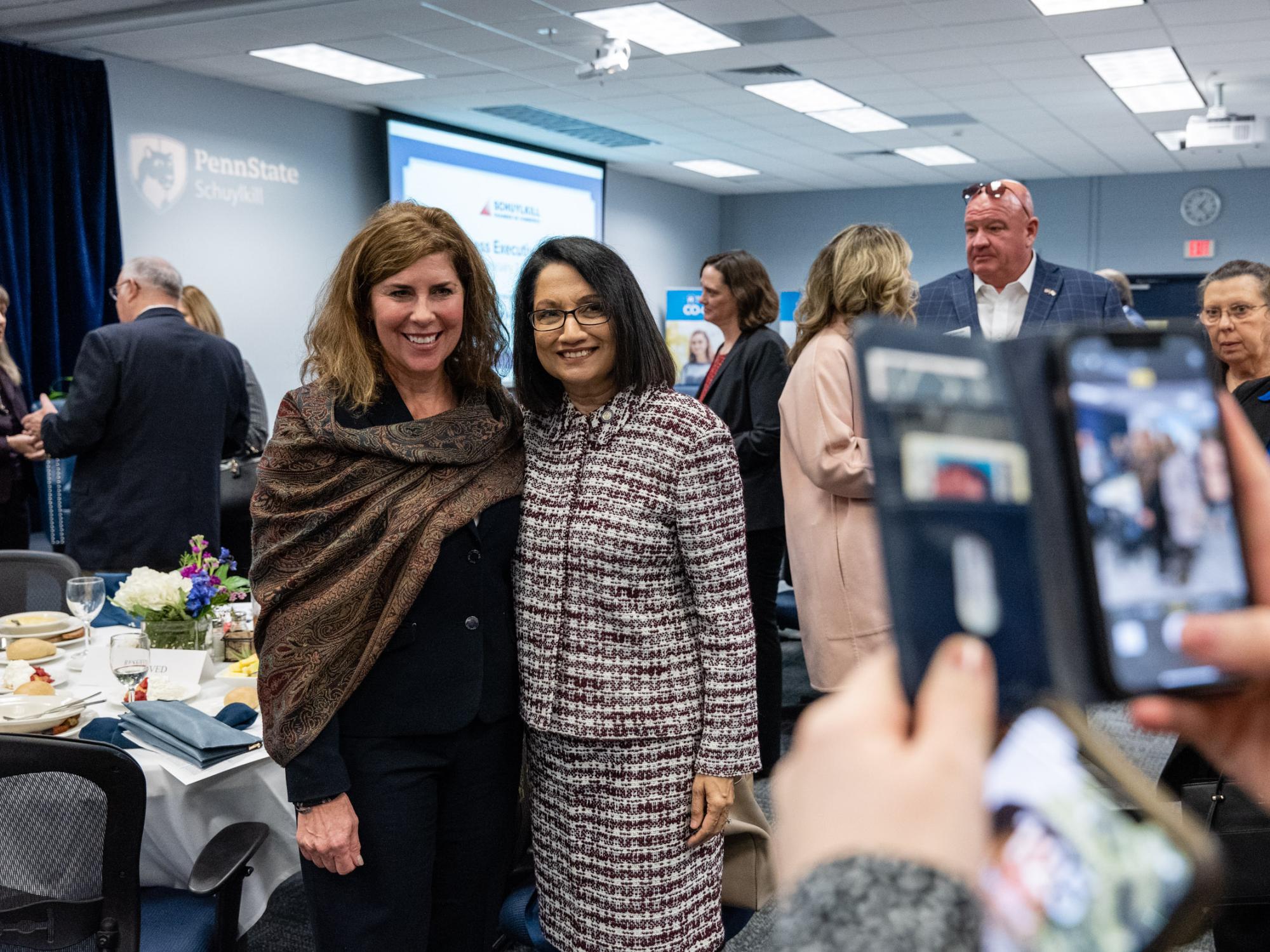 A cell phone photo is taken of two women
