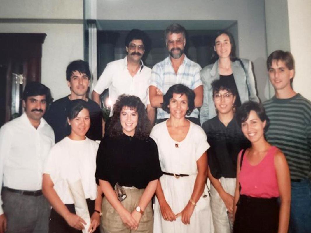 Joanna Floros stands among ten members of her research lab at Harvard Medical School in the 1980s. 
