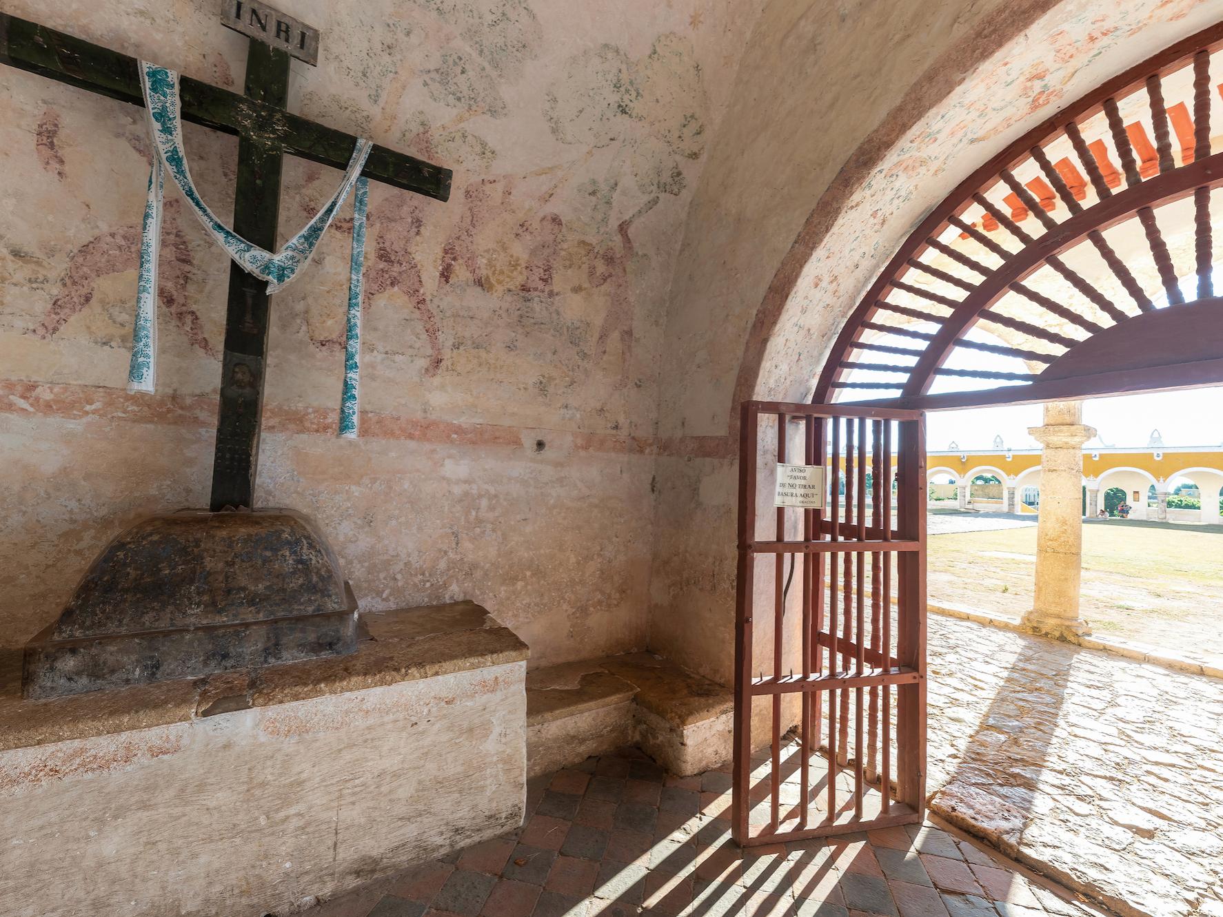 Doorway to old monastery with crucifix and courtyard