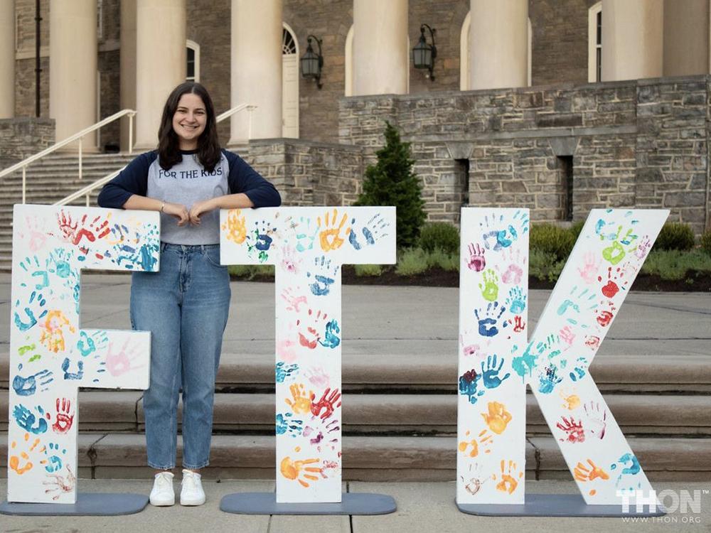 Lexi Murphy-Costanzo, the communications director for THON 2023, stands in front of Old Main.