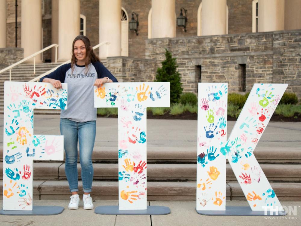 Gwen Yetter, the supply logistics director for THON 2023, stands in front of Old Main.