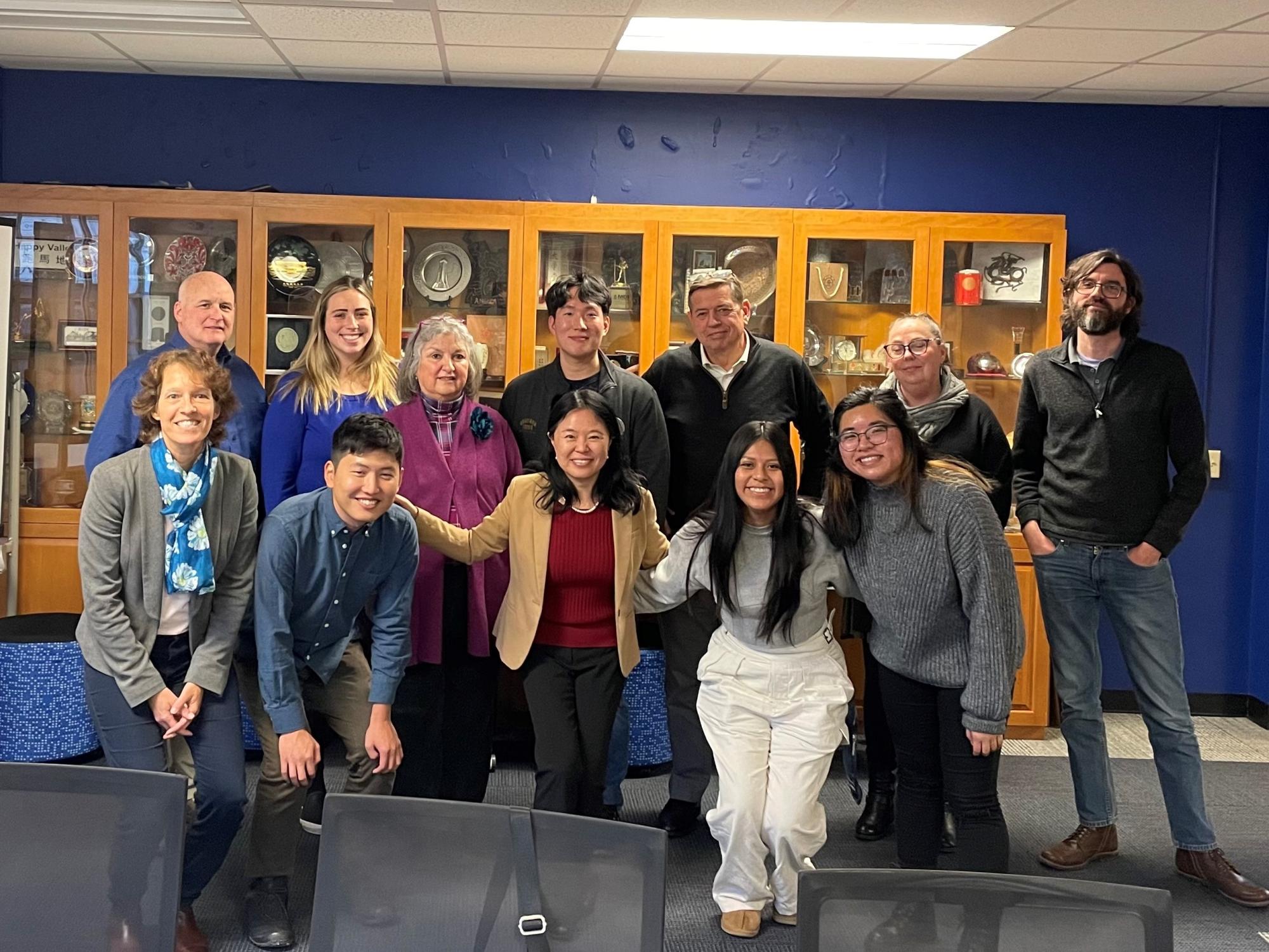 An image of a group of people at a farewell party