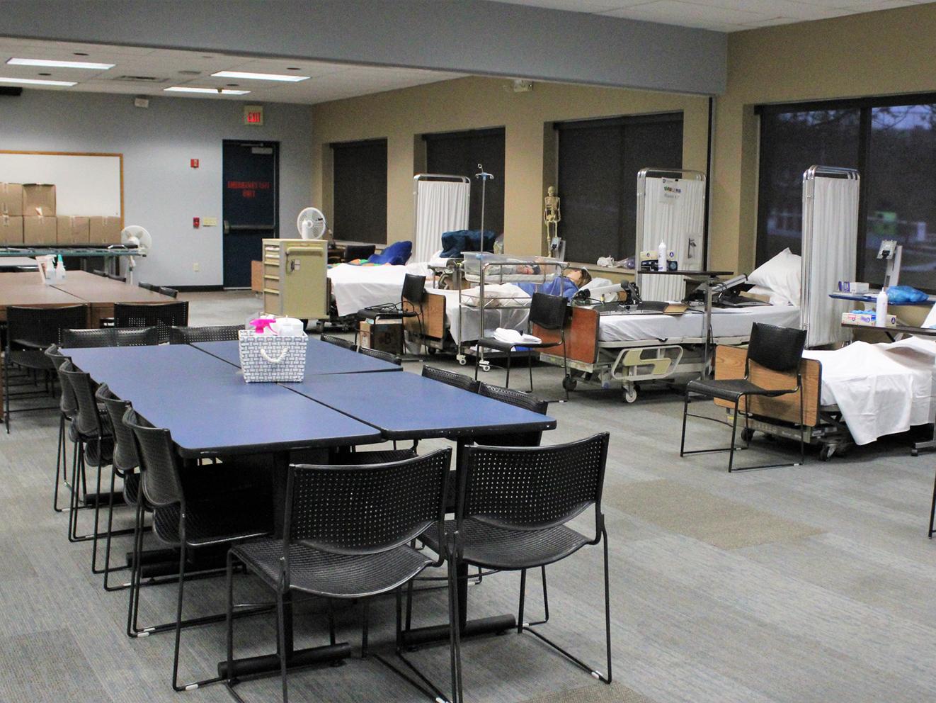 hospital beds with patient simulators on them, and a conference table and chairs in GCC 112, the temporary home for nursing