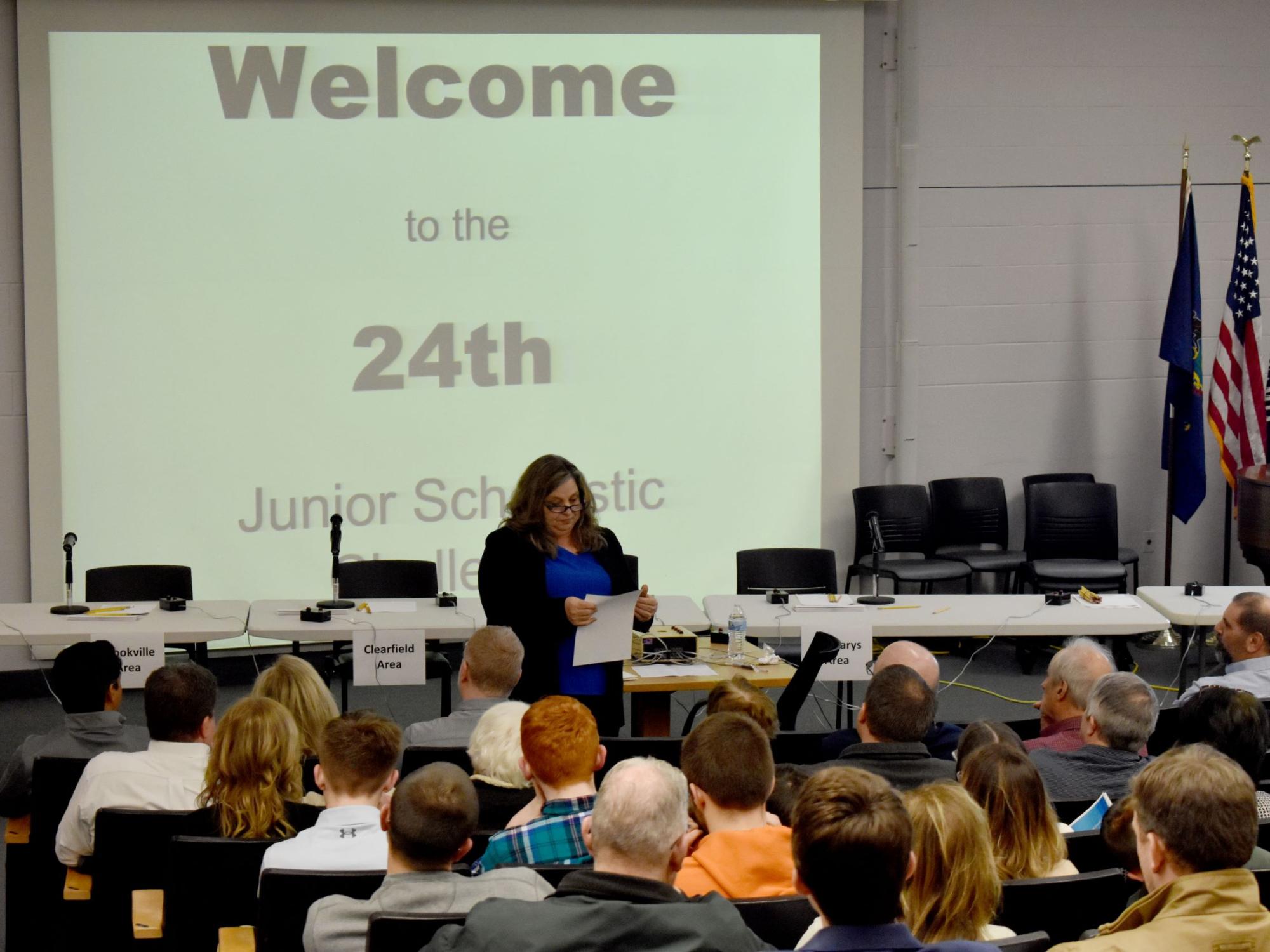 Carol Foltz of Coldwell Banker Developac Realty gives instructions to those in attendance in the Hiller Auditorium during the junior scholastic challenge