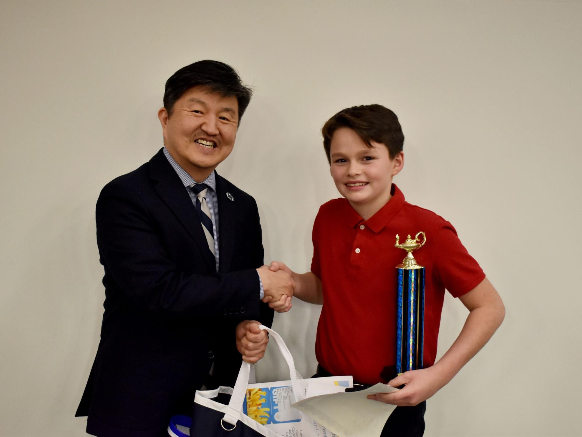 Xavier O’Link of Clearfield, right, receives the individual award for the final rounds from Jungwoo Ryoo, chancellor and chief academic officer of Penn State DuBois