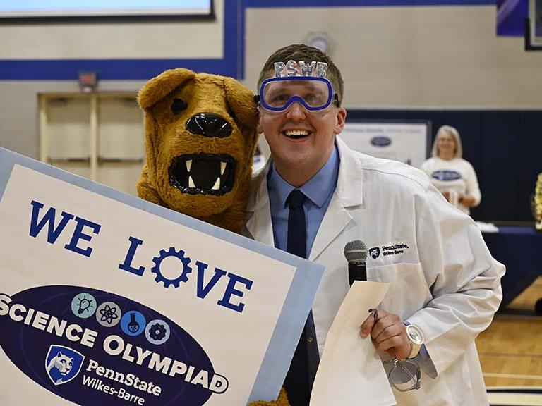The Nittany Lion posing with a man serving as host of the event.