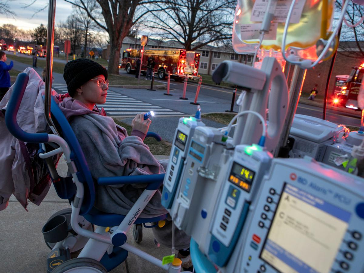 A teenager watches a parade