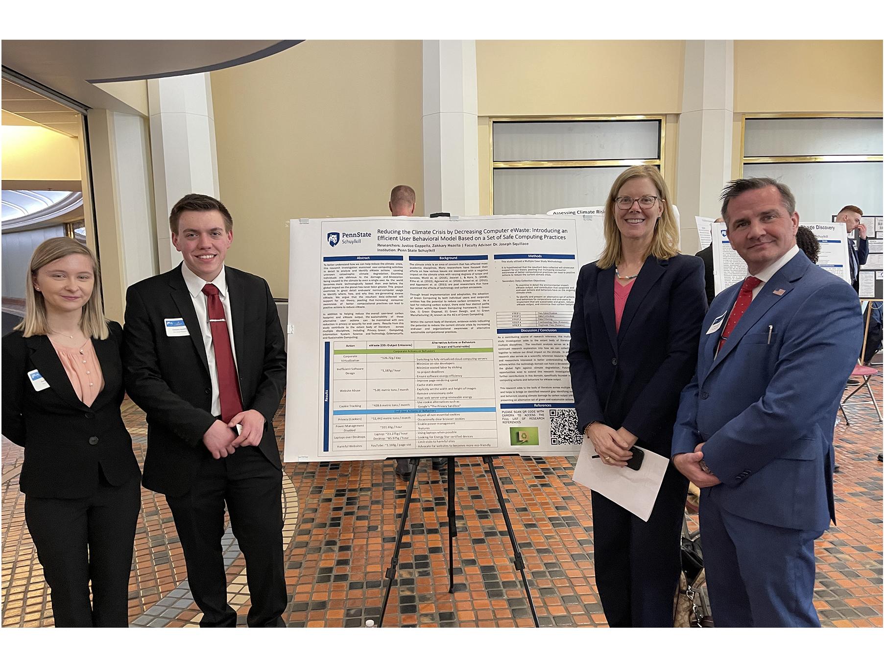 Students Justice Cappella and Zakkary Hozella pictured with faculty mentor and a poster on an easel
