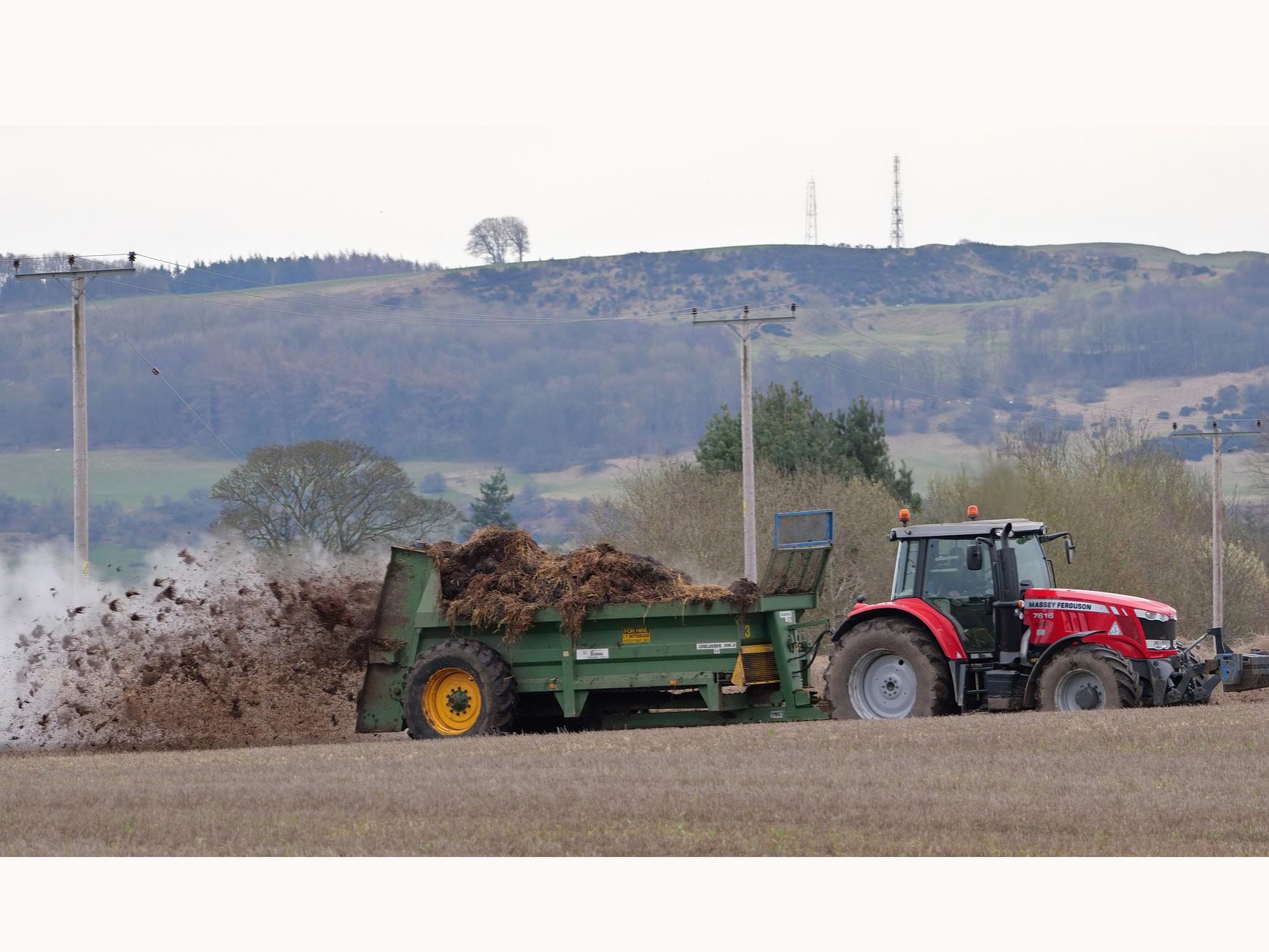muck spreading by a tractor and truck