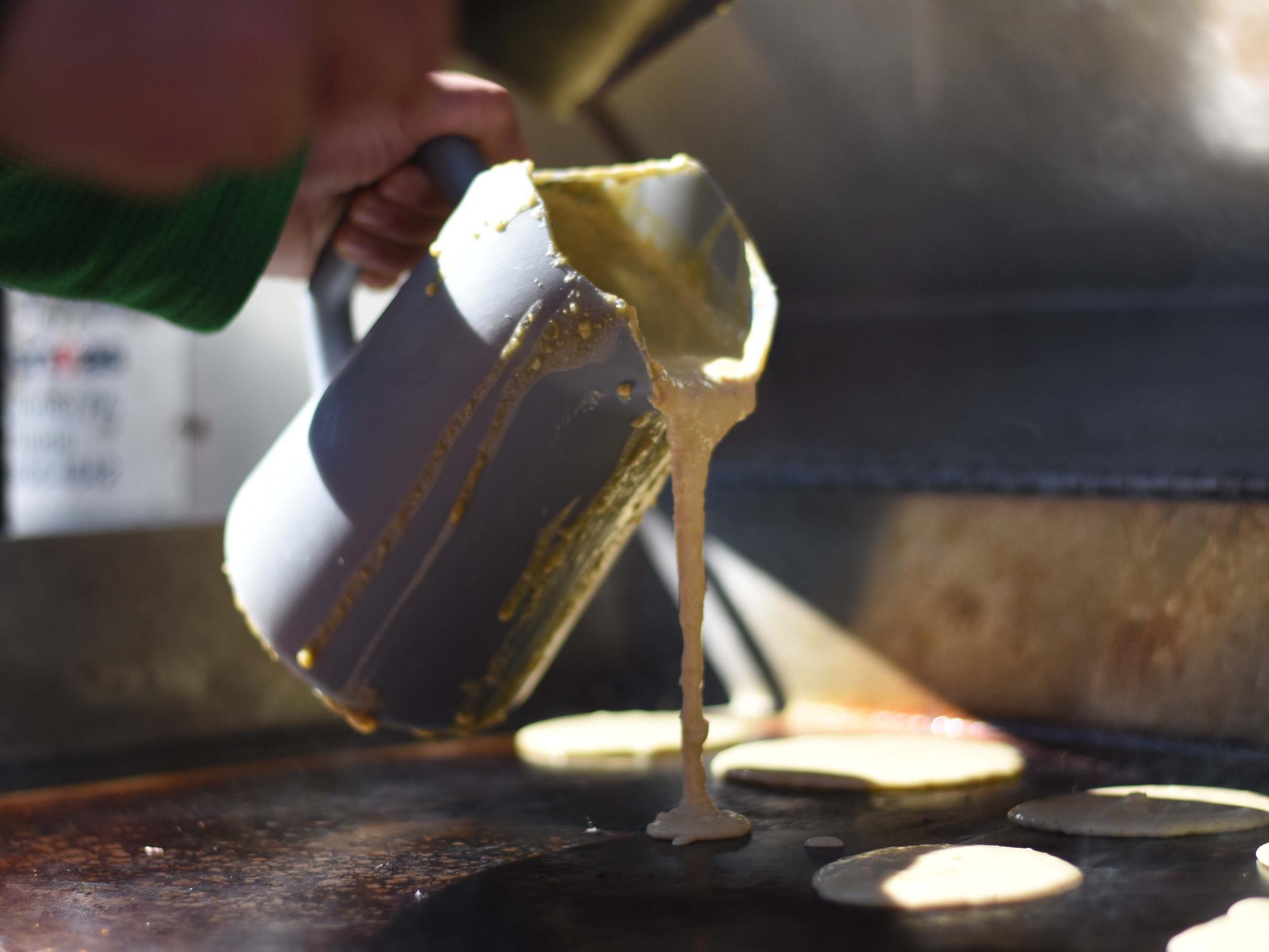 Pancake batter pouring on outdoor grill