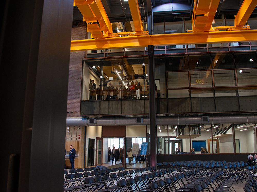 people view down from a second-story viewing area to the ceremony chairs on the first floor