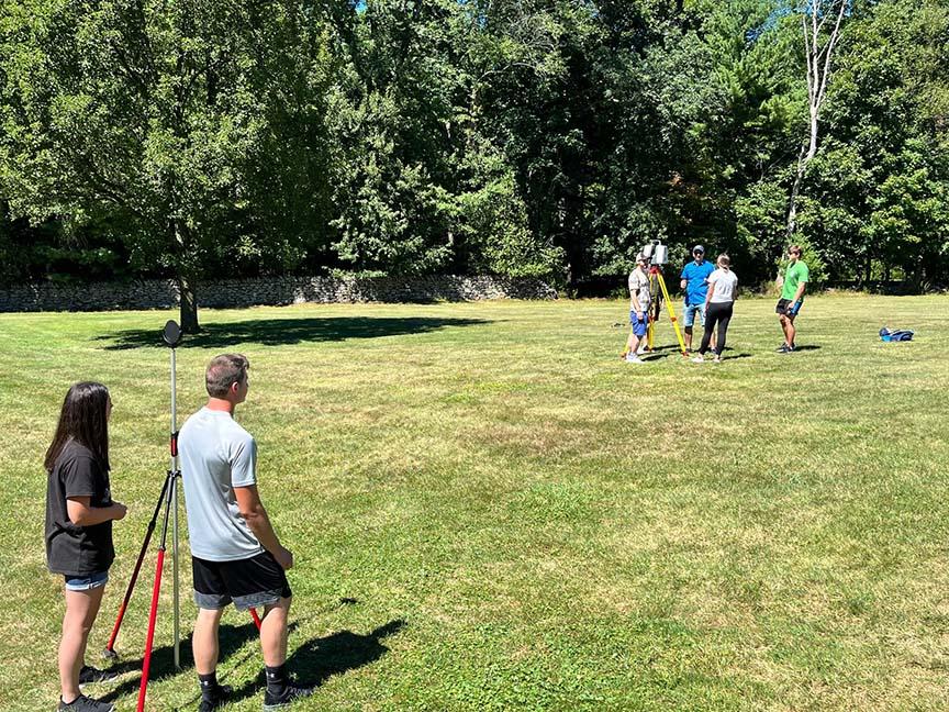 Surveying engineering students working outside