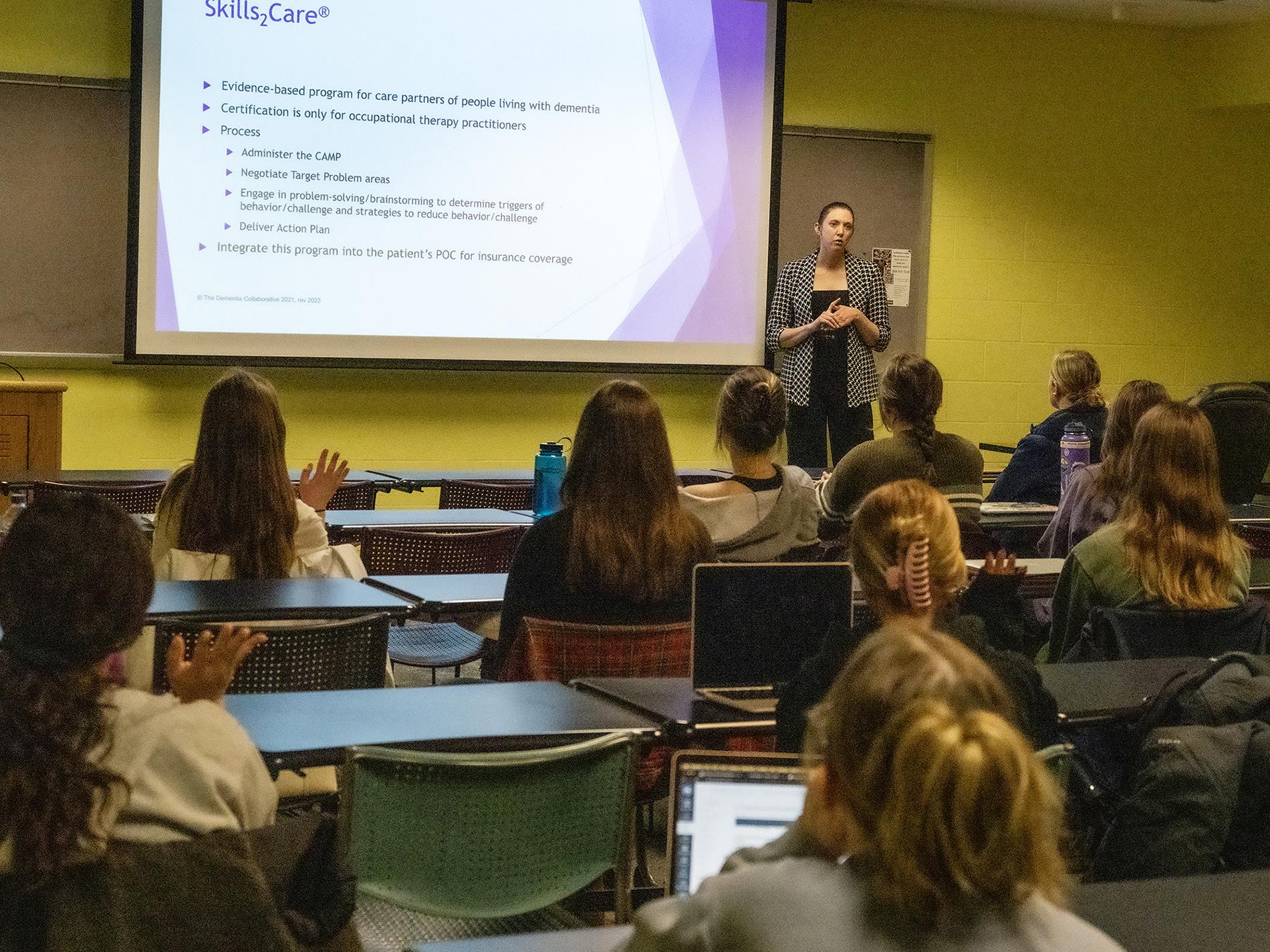 Woman engaging with classroom of students