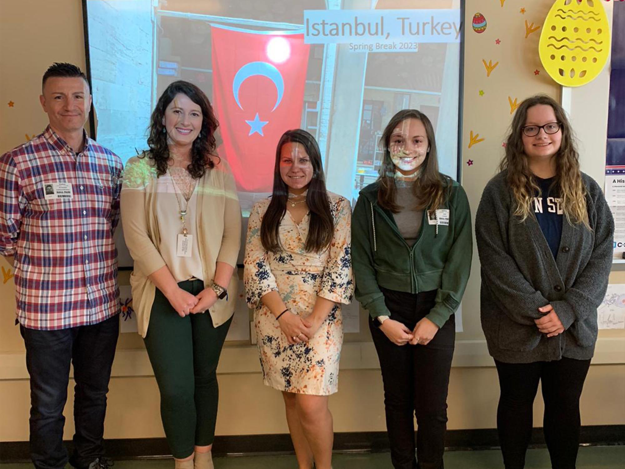 Dr. Karagiorgakis and his students presenting in front of a class