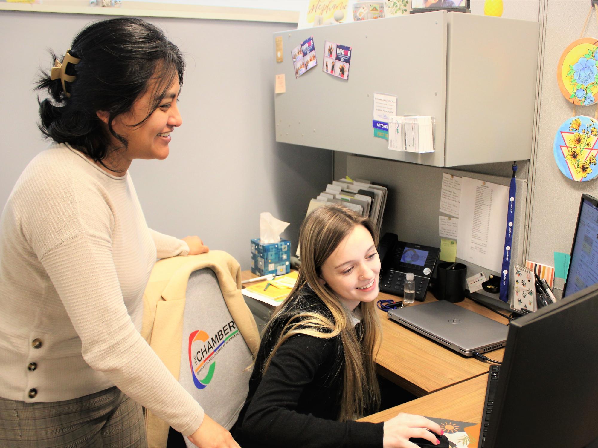 Penn state scranton intern Taylor Burdick on the job at the chamber shown collaborating at her computer with her supervisor