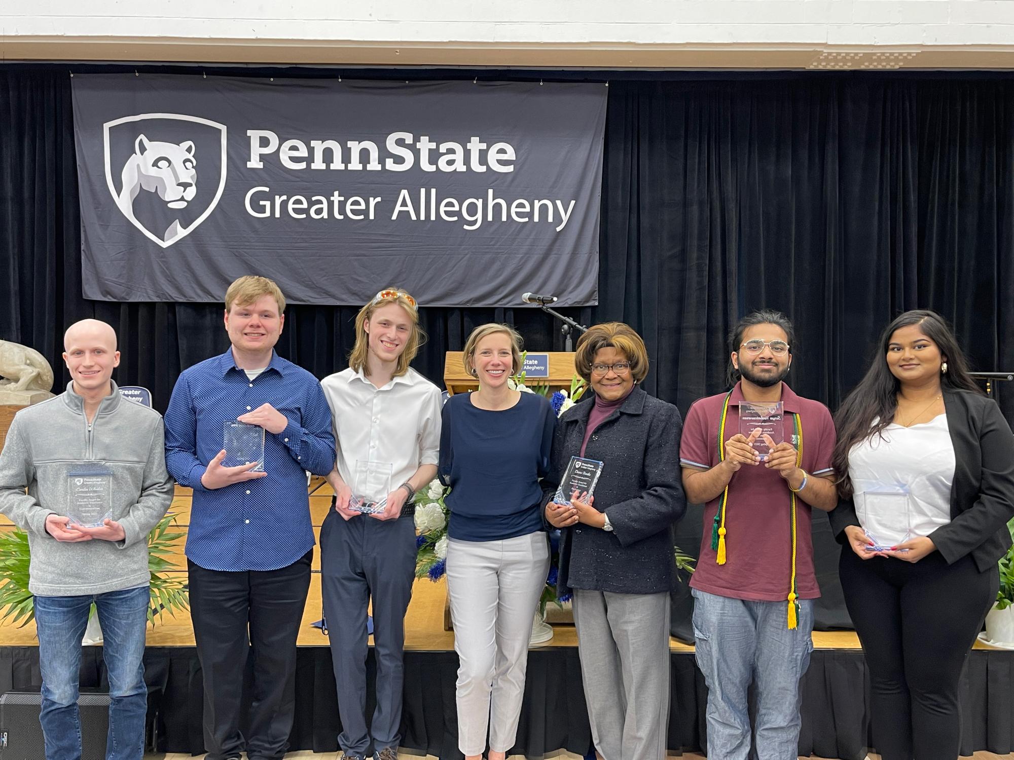 people holding awards and smiling