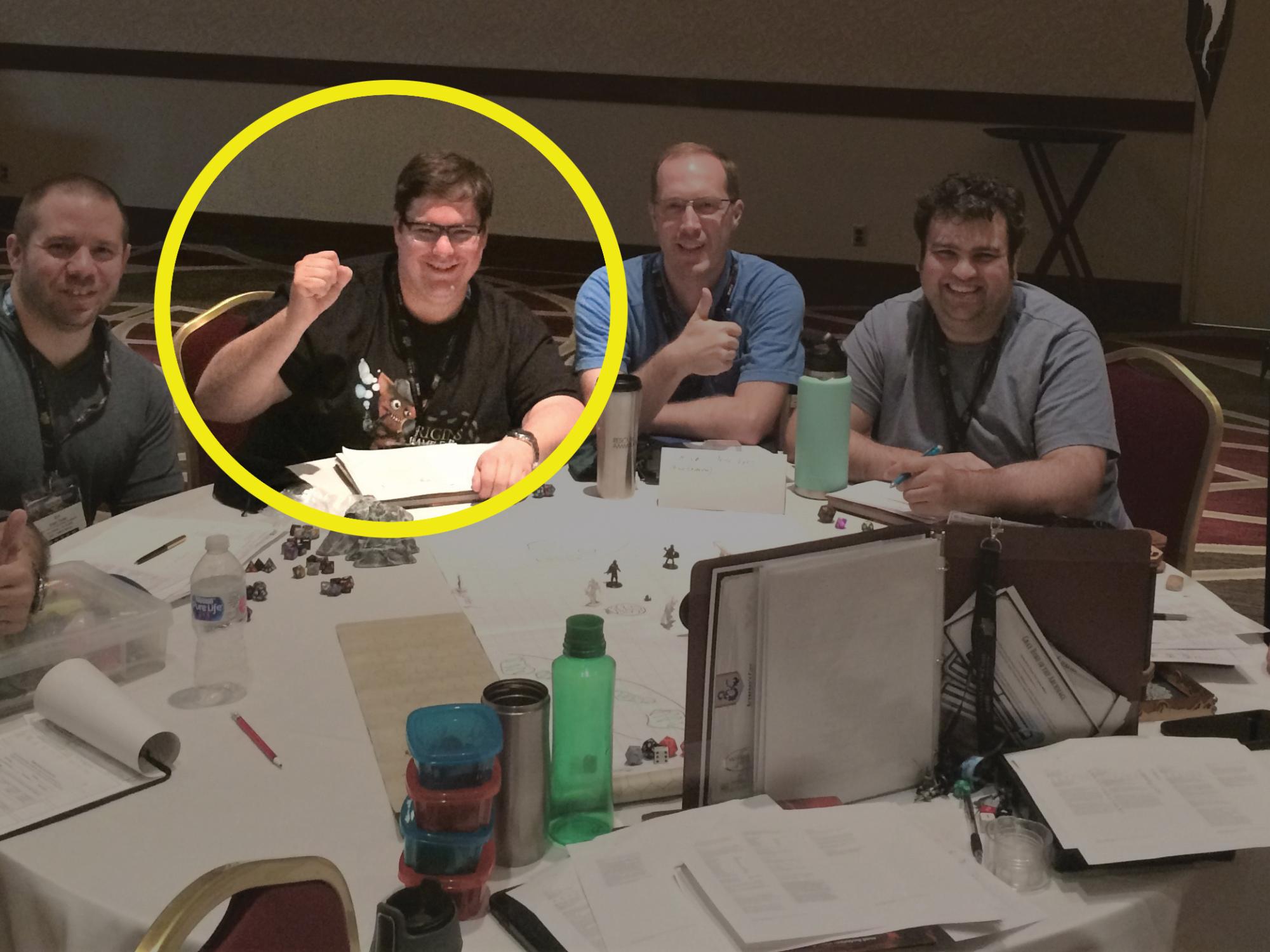 Scott Metzger circled in yellow while sitting at table playing Dungeons & Dragons with group of friends