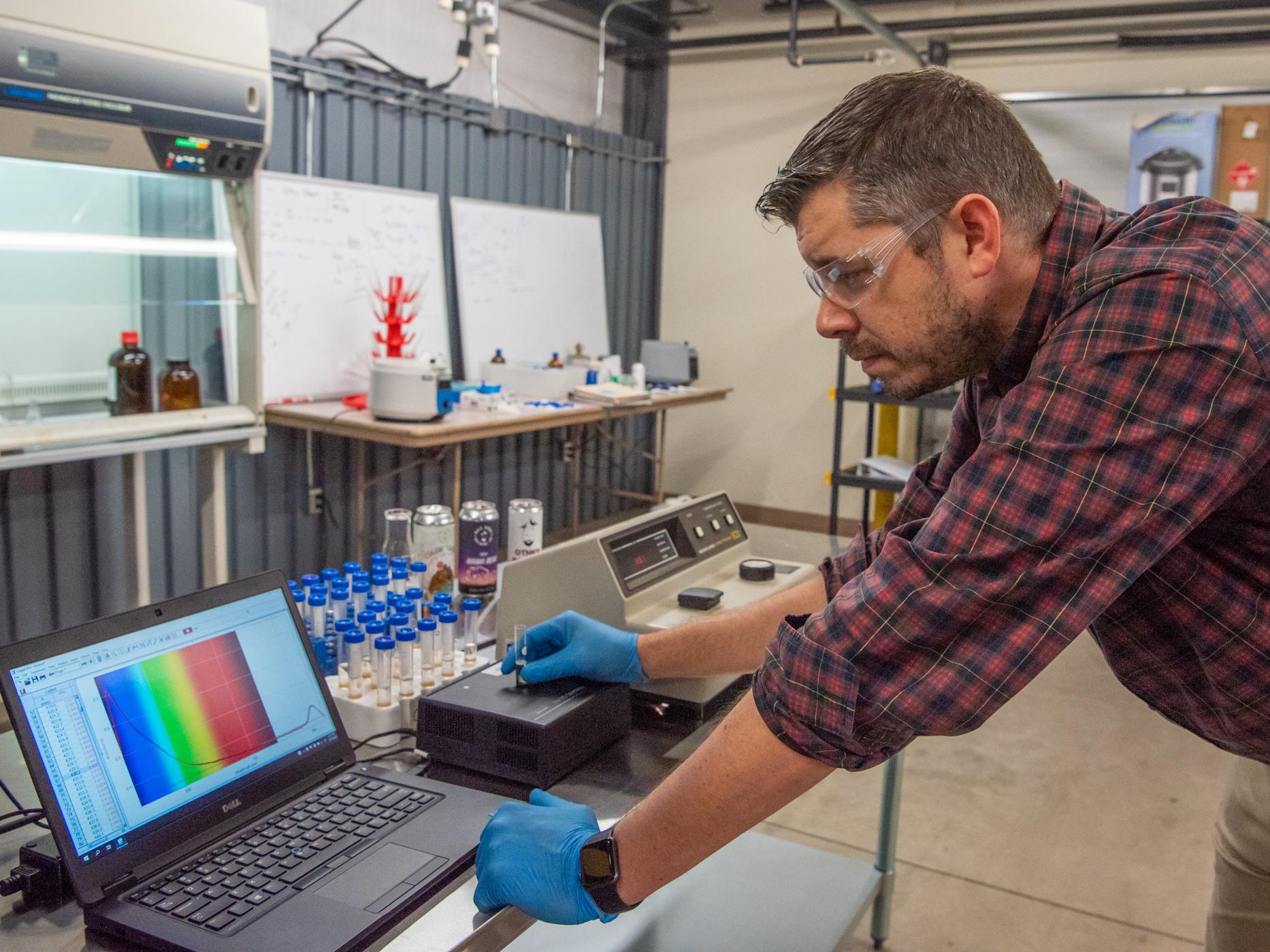 Justin Ingram works at a lab station