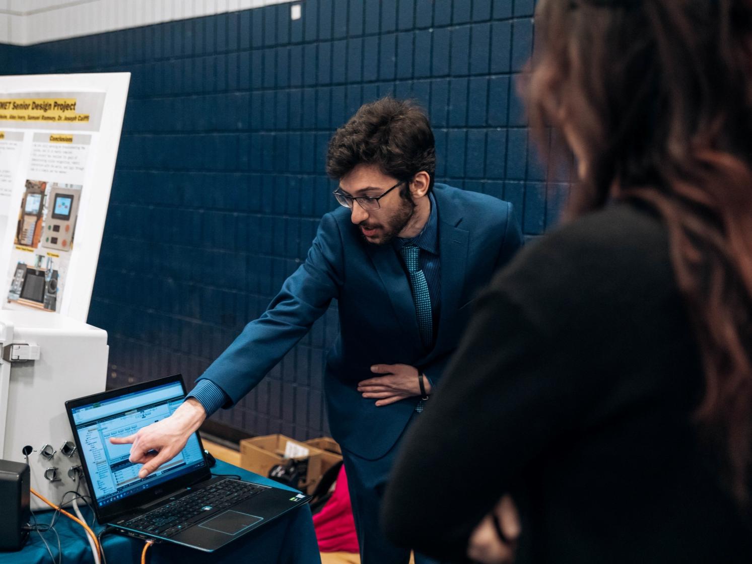 Student points at computer