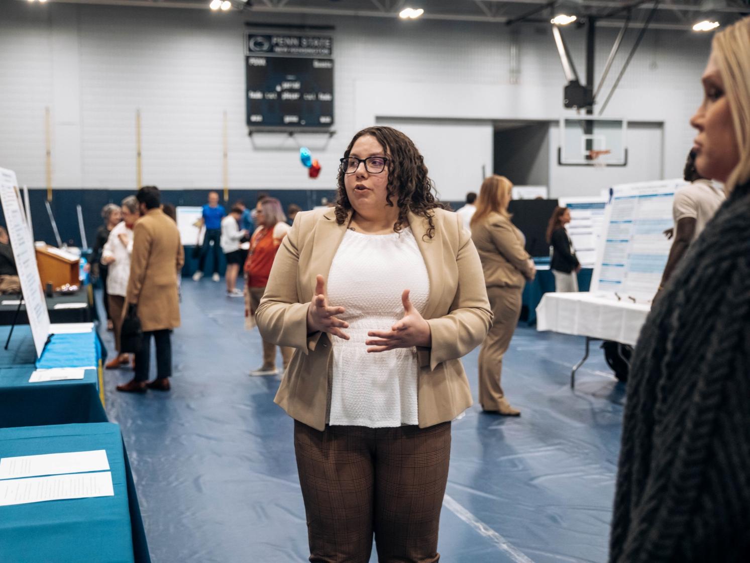 Student stands at research fair